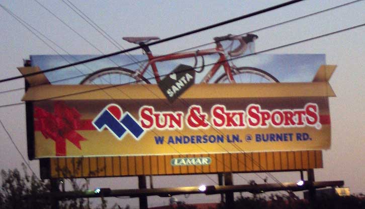 MusiGraphics billboard design for Sun & Ski Sports, featuring a bicycle and brand message
