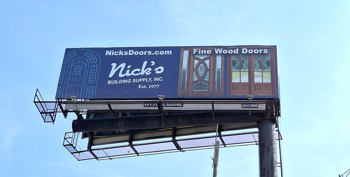 Nick's Building Supply billboard featuring fine wood doors