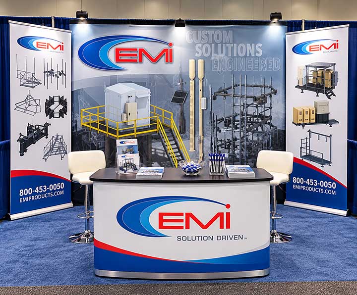 EMI industrial trade show booth display with branded backdrop, counter and retractable banners